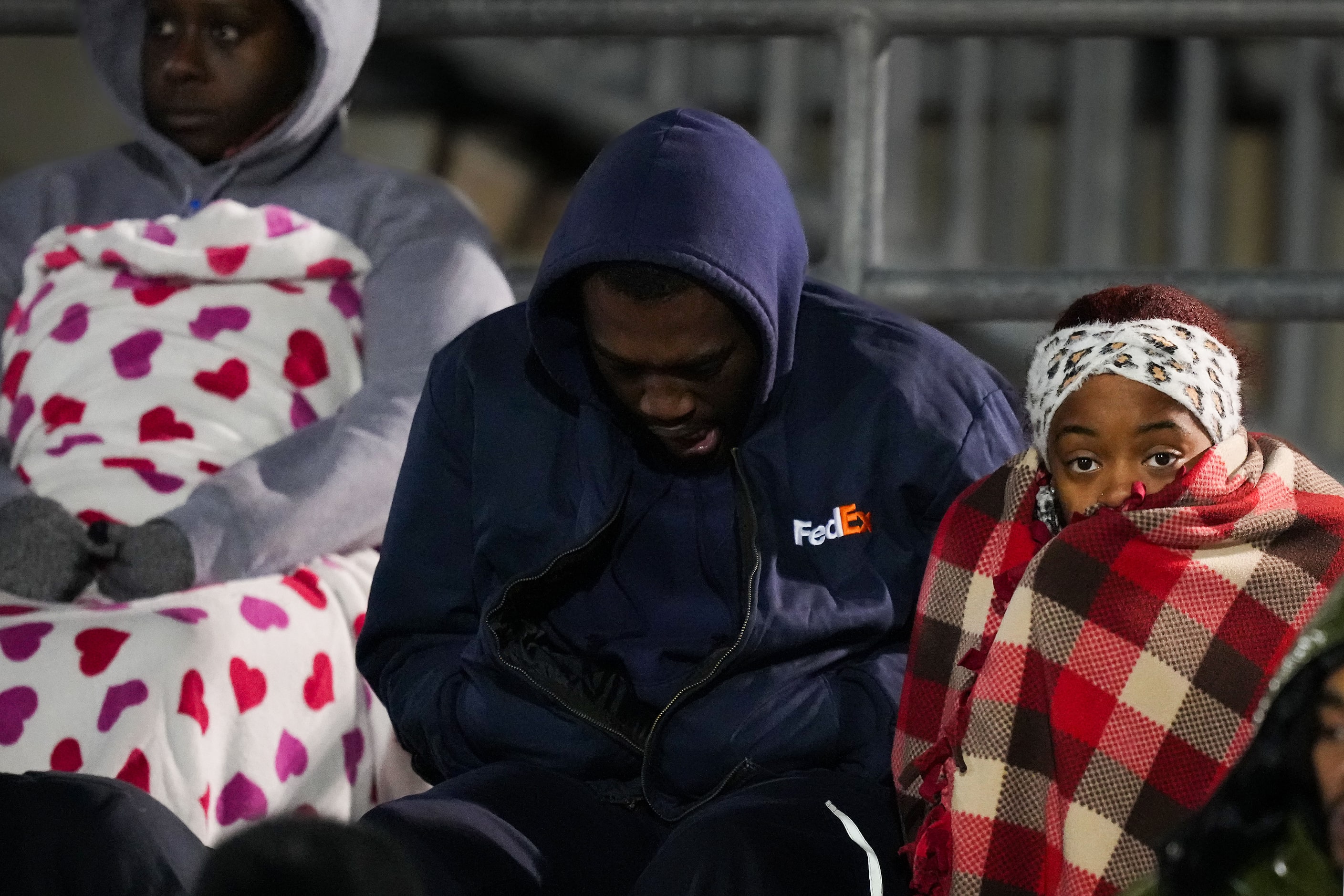 Arlington Bowie fans huddle against chilly temperatures during the second half of a Class 6A...