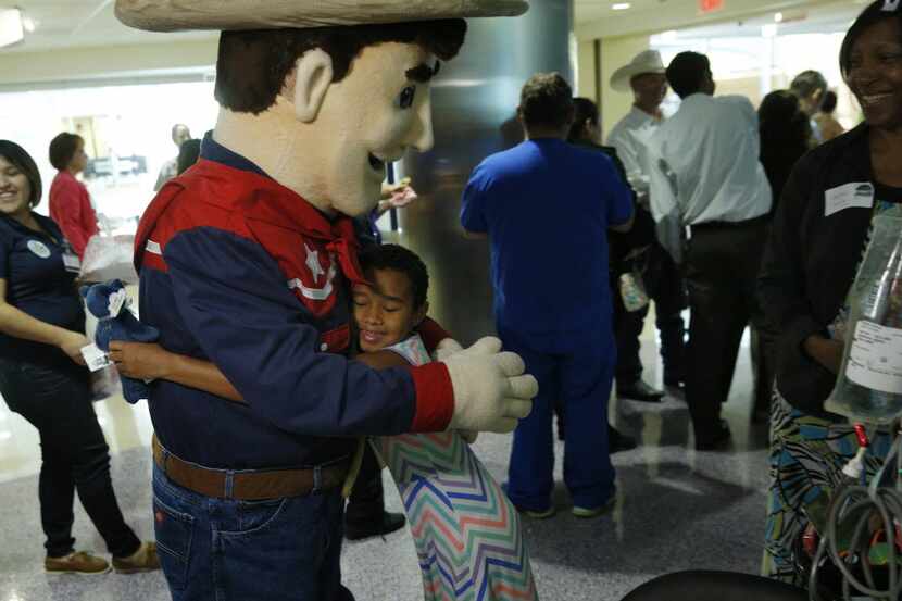 Micah Barrera, 9, managed to get her arms around a smaller version of the State Fair icon,...