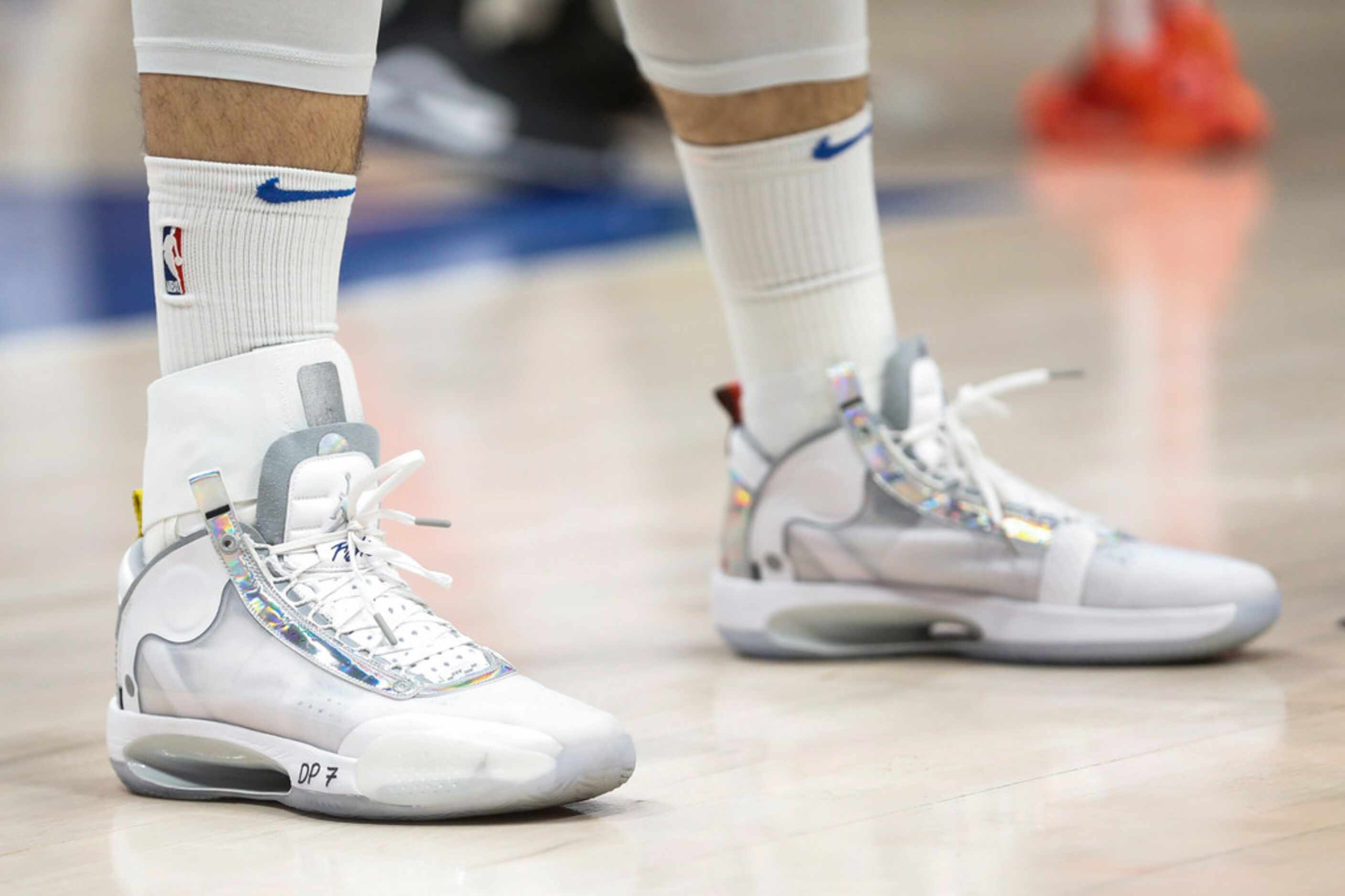 An ankle brace is worn by Dallas Mavericks guard Luka Doncic (77) on the right ankle during...