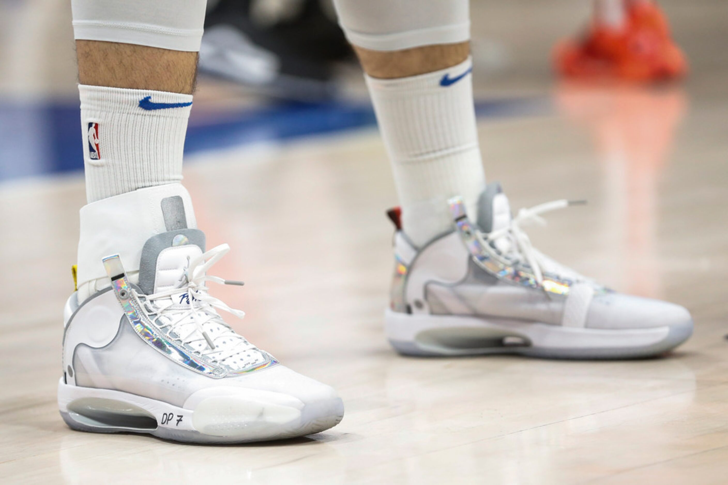 An ankle brace is worn by Dallas Mavericks guard Luka Doncic (77) on the right ankle during...