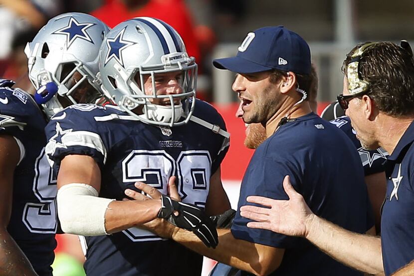Dallas Cowboys strong safety Jeff Heath (38) is congratulated by teammate Tony Romo after...