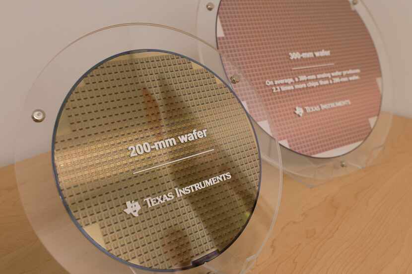 A 200-mm wafer and a 300-mm wafer side by side at Texas Instruments' newest fabrication...