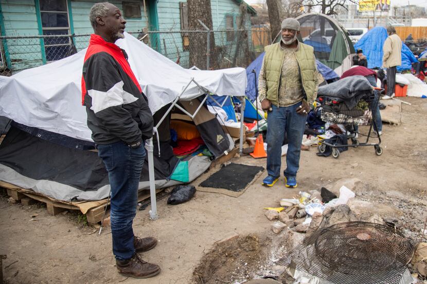 Melvin Hunter (left) chats with Andre Collins at Camp Rhonda, a homeless encampment located...