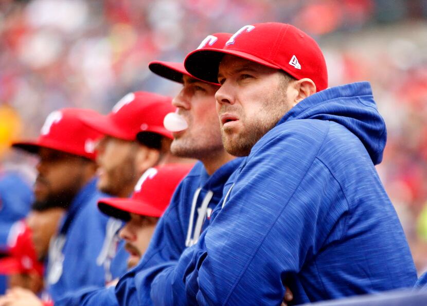 Texas Rangers starting pitchers Colby Lewis (right) and Cole Hamels watch the game from the...
