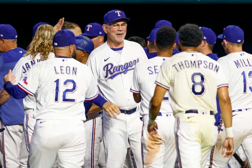 Texas Rangers manager Bruce Bochy (center) celebrates with players after a walk-off home run...