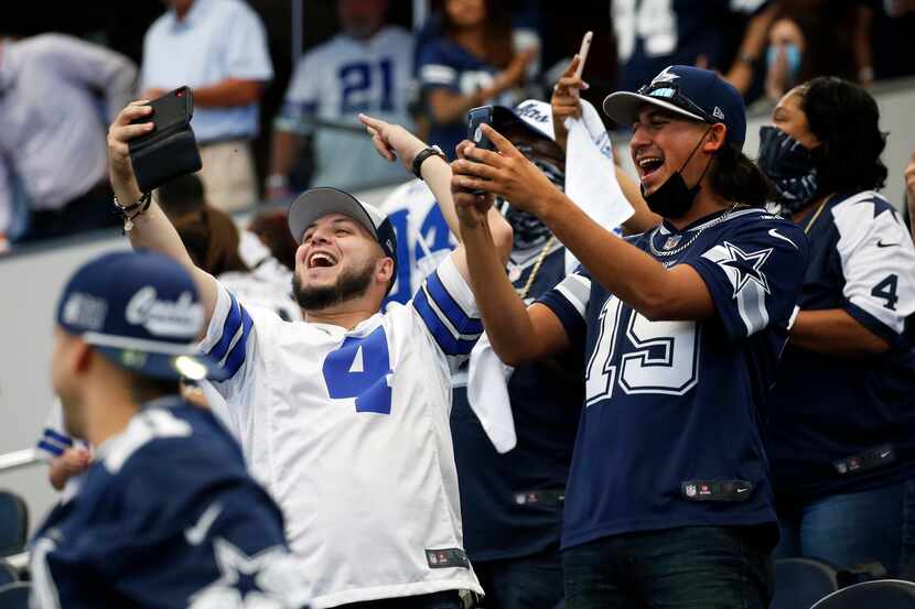 Dallas Cowboys fans celebrate after Dallas Cowboys kicker Greg Zuerlein (2) kicks the...