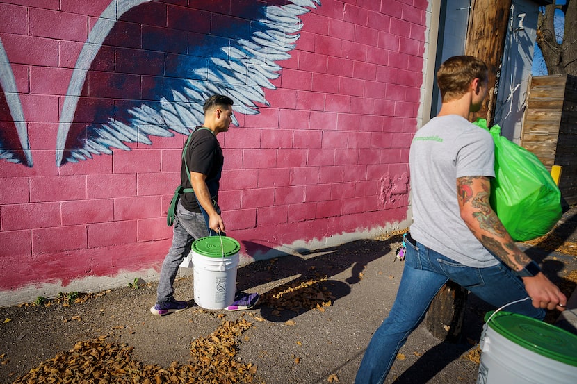 Donny Sirisavath (left), the chef and owner of Khao Noodle Shop, helps Wes Fitch of Turn...