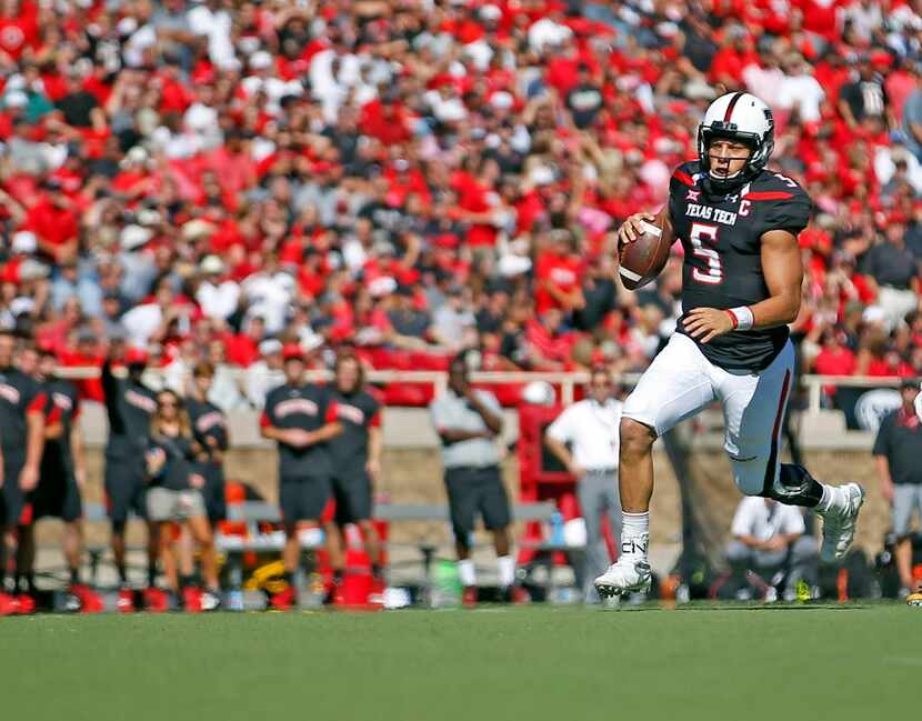 Texas Tech's Patrick Mahomes (5) runs the ball down the field against West Virginia during...