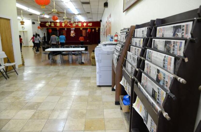 
Racks of Chinese newspapers line the walls of the Dallas Chinese Community Center while a...