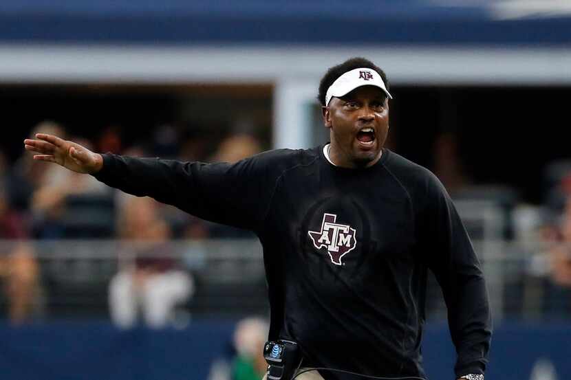 FILE - In this Sept. 23, 2017, file photo, Texas A&M head coach Kevin Sumlin talks to an...