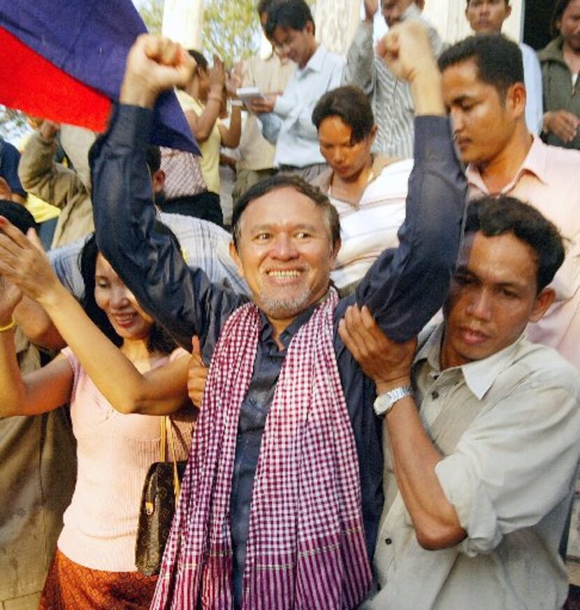 Kem Sokha from the U.S.-funded Cambodian Center for Human Rights celebrates with his...