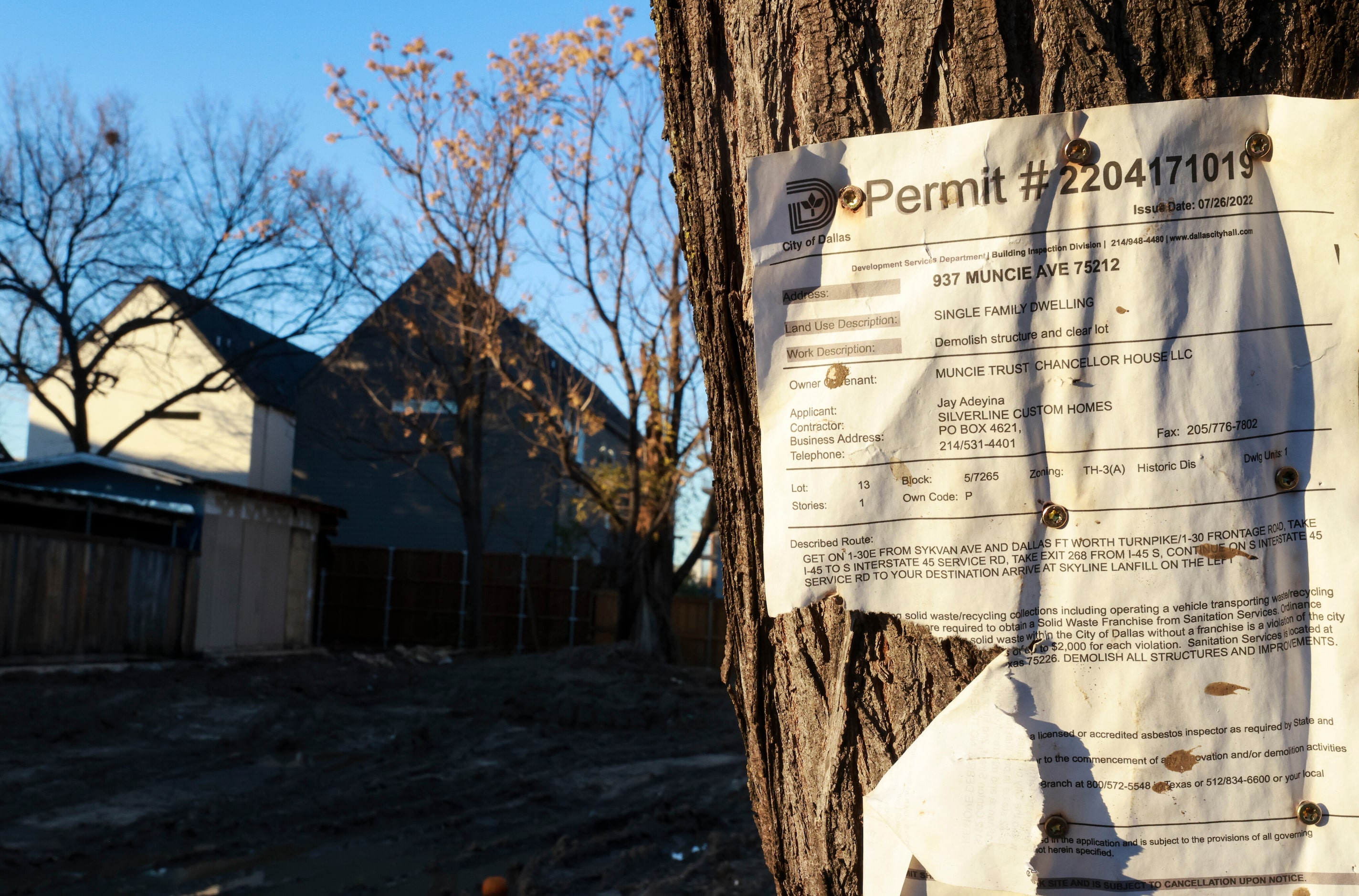 A permit left on a tree after a home was knocked down and where a new one can be built...