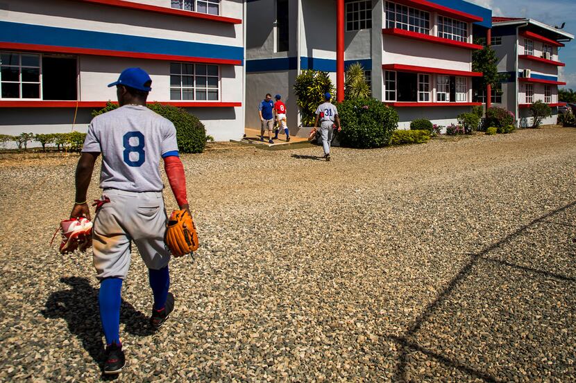 FILE - Infielder Luisangel Acuna heads toward the dorms after a tryout game at the Rangers'...