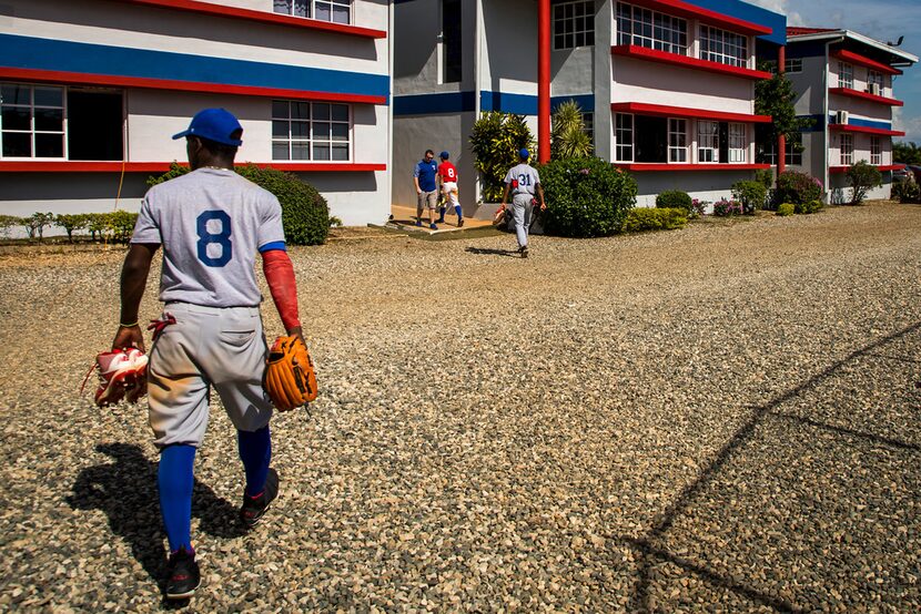 Infielder Luisangel Acuna head toward the dorms after a tryout game at the Texas Rangers...