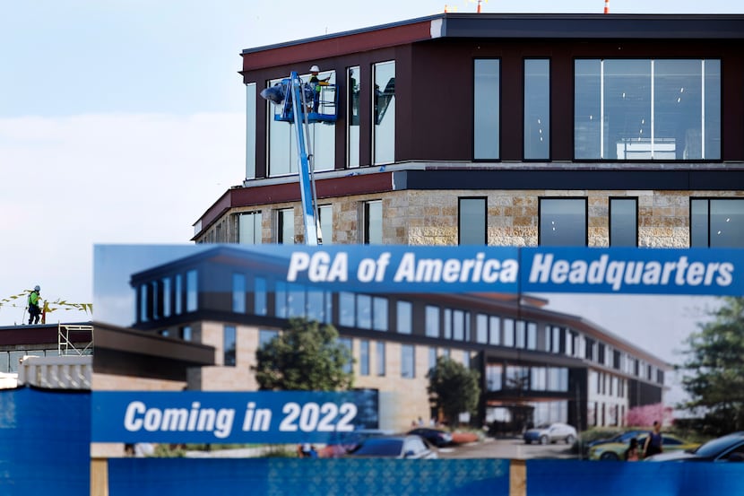 Construction crews work on the exterior of the new PGA of America Headquarters in Frisco,...