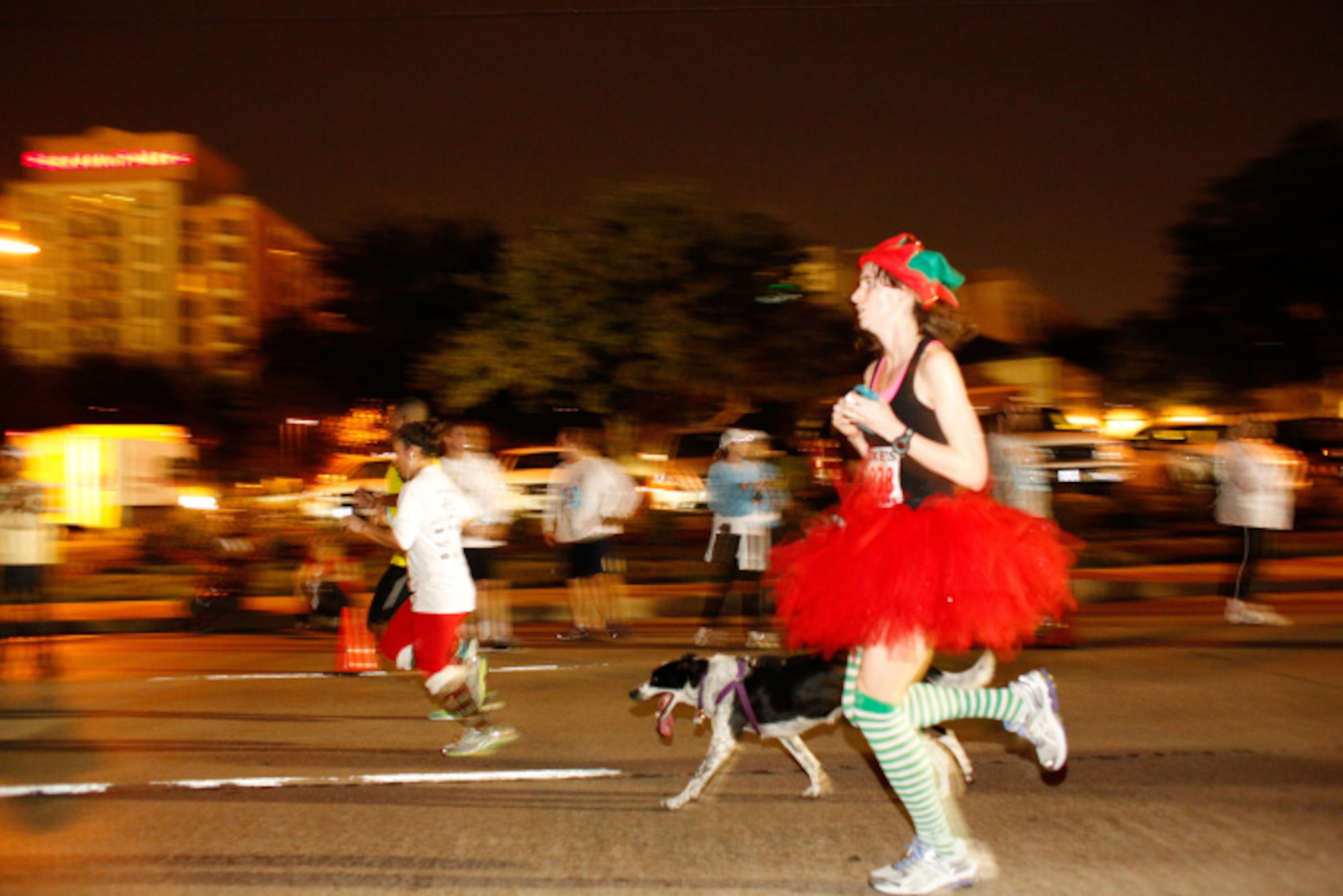 Thousands of runners take the streets for the Jingle Bell Run outside the Hilton Anatole in...