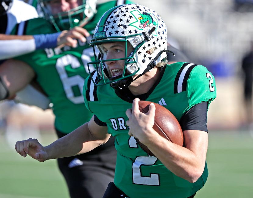 Southlake High School quarterback Angelo Renda (2) runs the ball during the first half as...