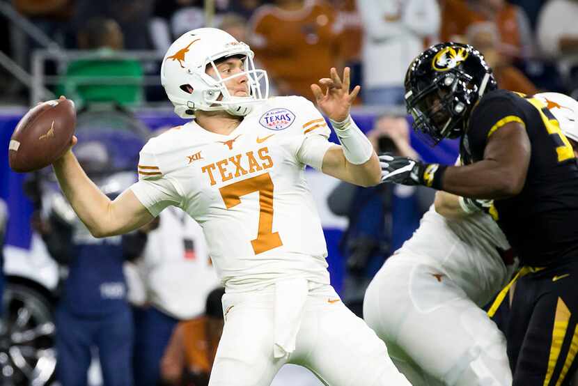 Texas quarterback Shane Buechele (7) throws a pass under pressure from Missouri defensive...