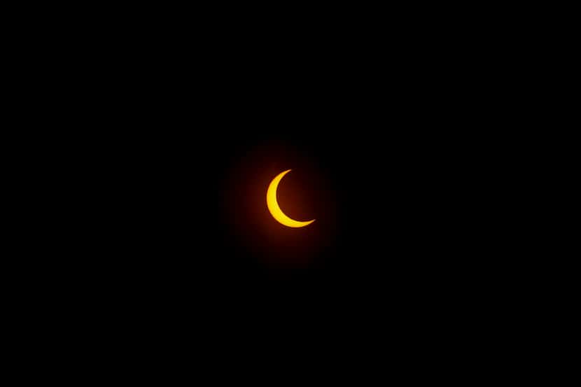 File image of annual solar eclipse seen Oct. 14 from Perot Museum of Nature and Science in...