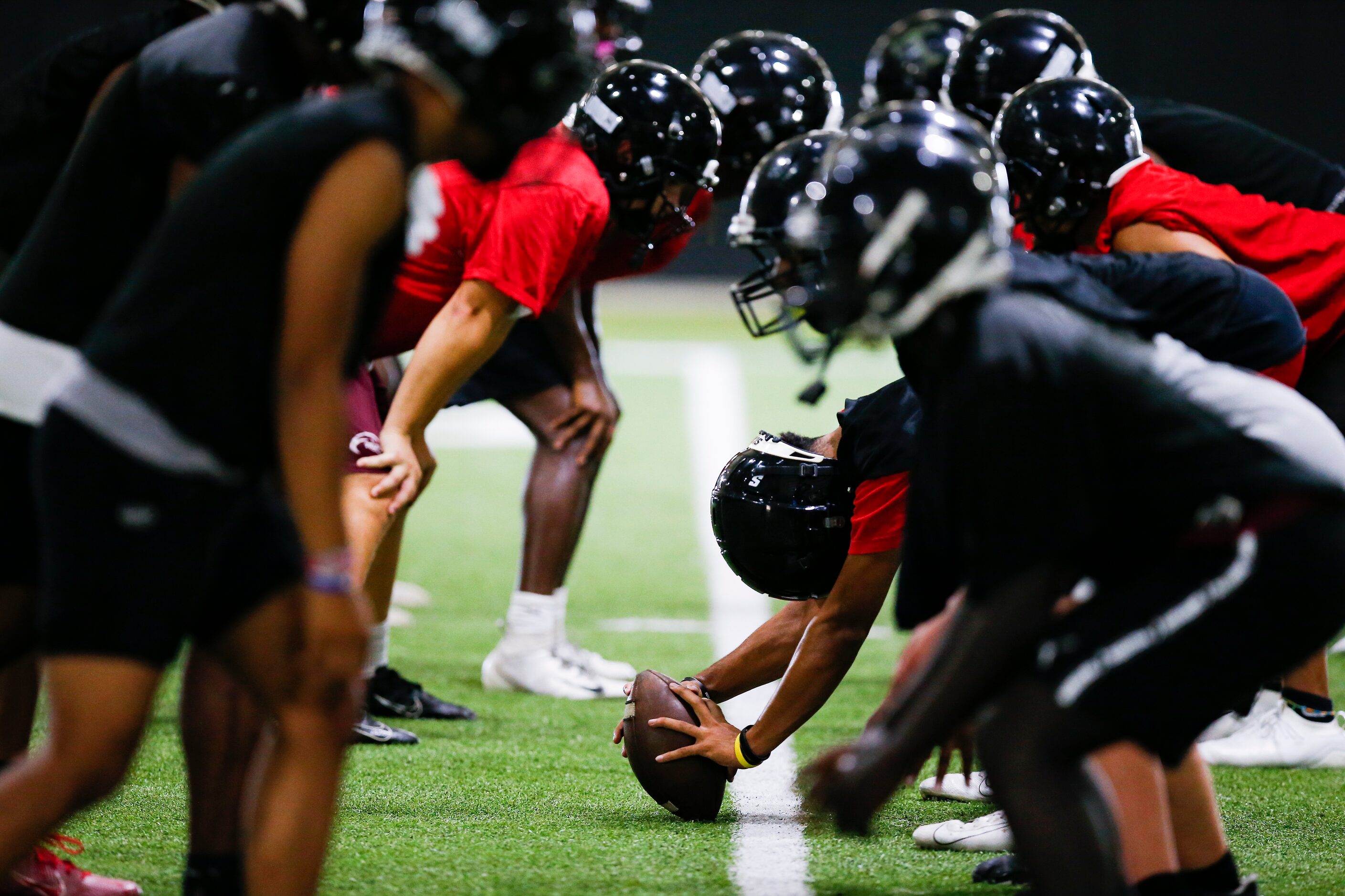 Euless Trinity’s varsity football team runs drills during a practice at Euless Trinity High...