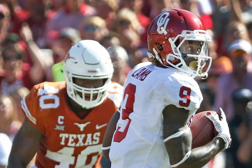 ]Oklahoma Sooners wide receiver CeeDee Lamb (9) catches a pass in front of Texas Longhorns...