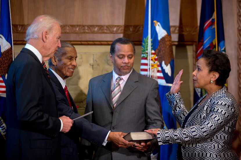 Loretta Lynch, right, is sworn in as the 83rd Attorney General of the U.S. by U.S. Vice...
