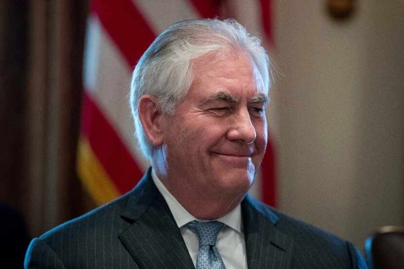 Secretary of State Rex Tillerson smiles as President Donald Trump speaks during a Cabinet...