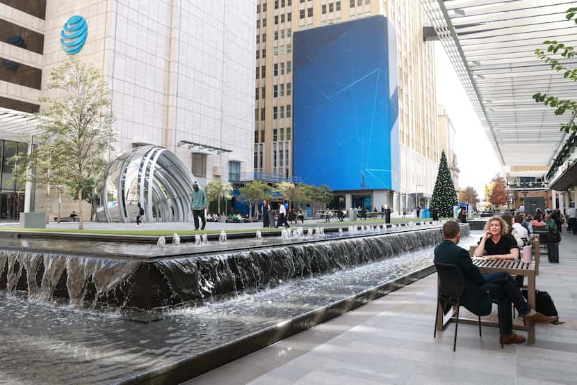 People mosey about the AT&T Discovery District, Tuesday, Dec. 6, 2022, in Dallas.