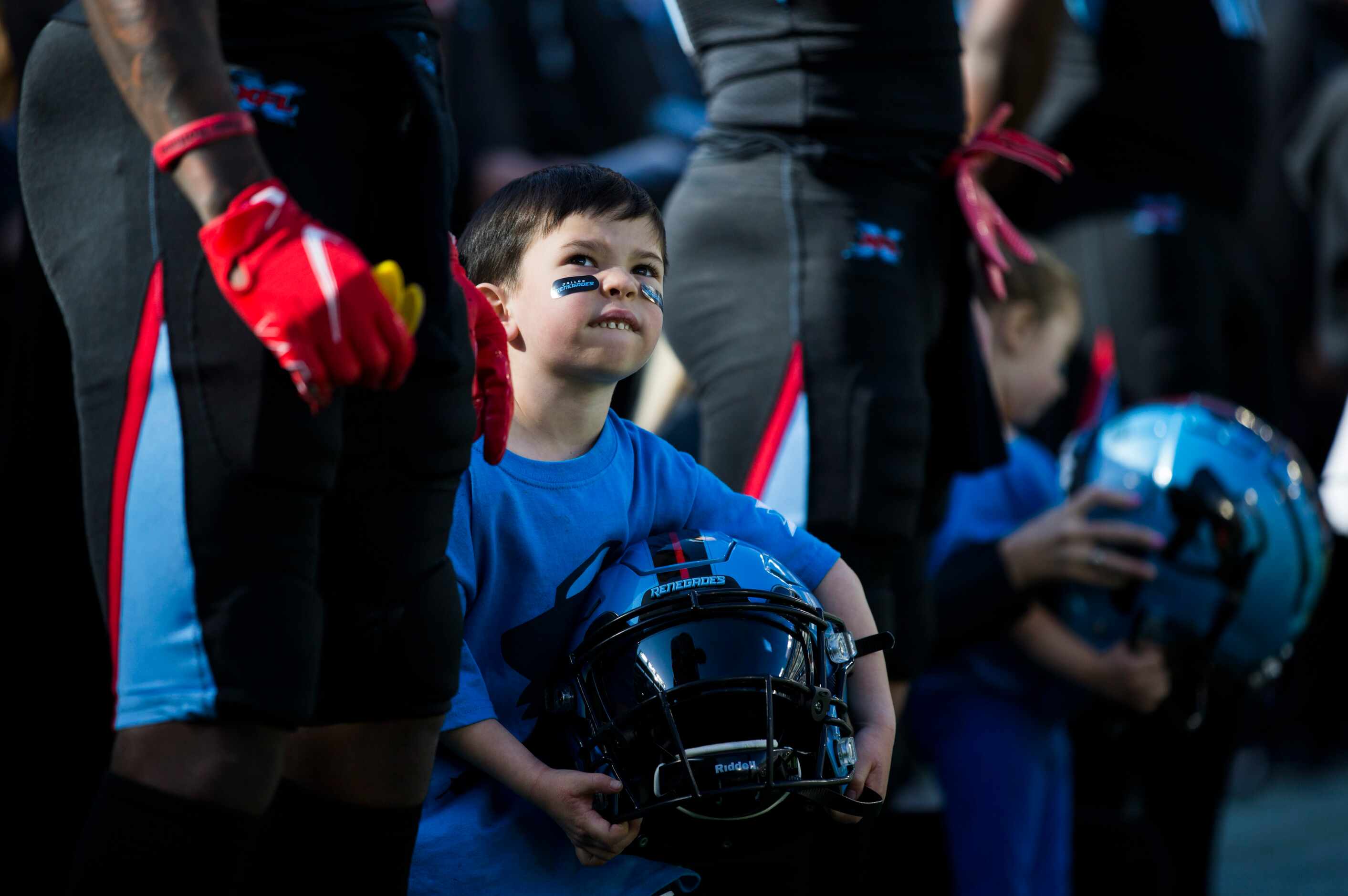 Liam Rickels, 5, holds the helmet of Dallas Renegades wide receiver Jeff Badet (13) during...