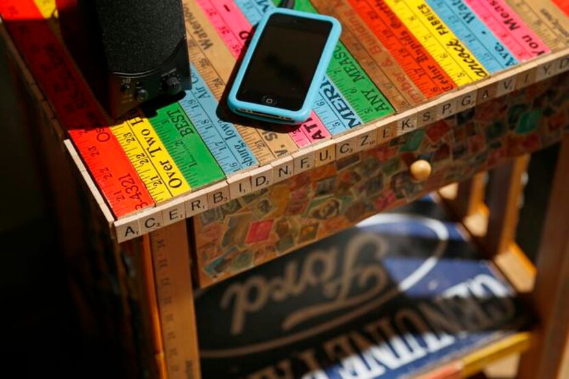 
Vintage yardsticks cover a nondescript yard-sale table. 
