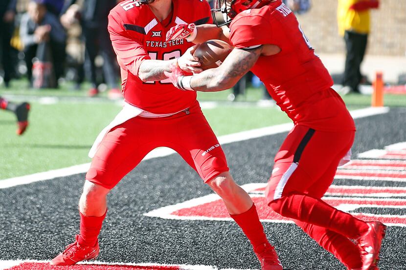 Texas Tech's Nic Shimonek (16) hands the ball off to Justin Stockton (4) during the first...