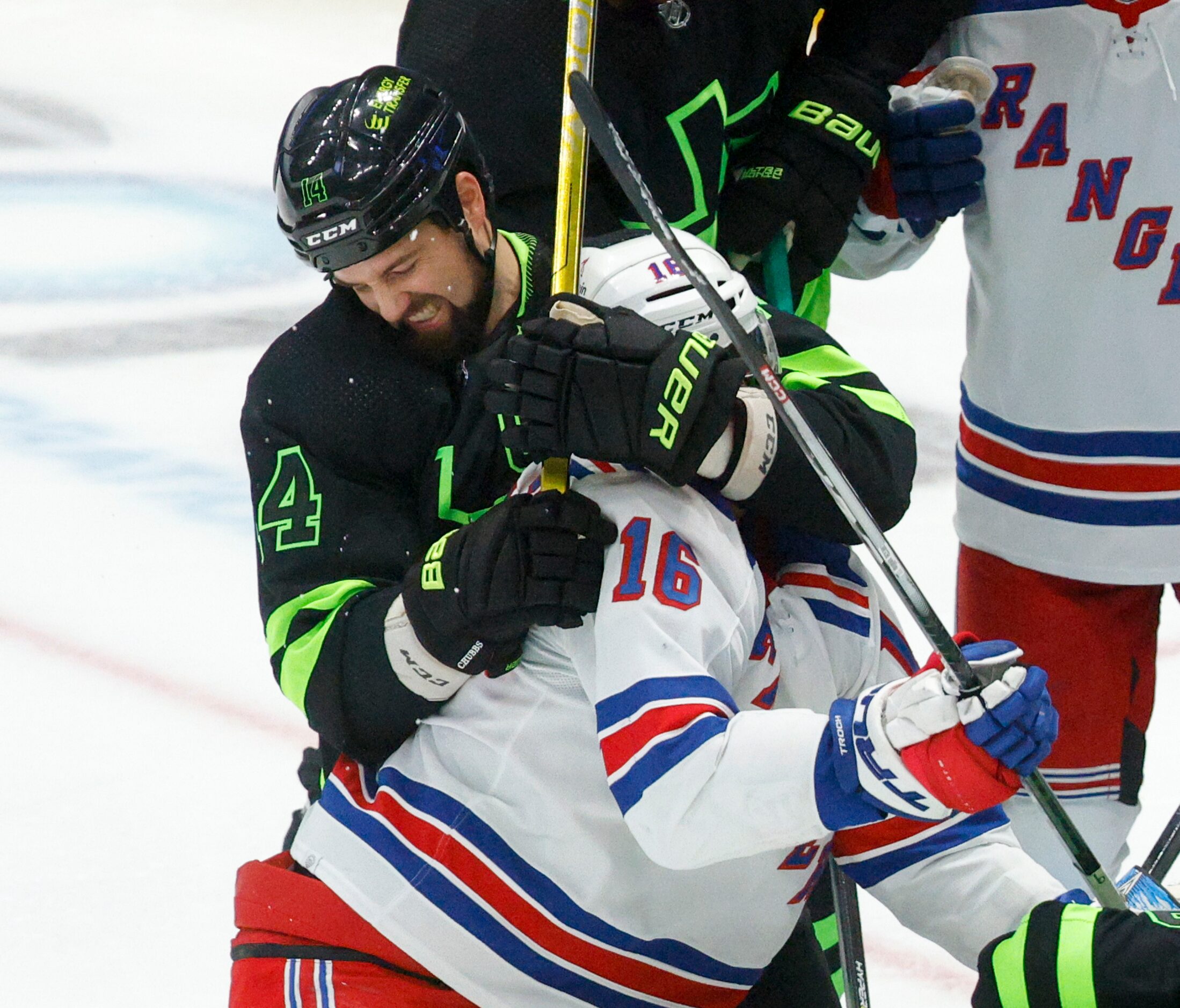 Dallas Stars left wing Jamie Benn (14) grabs New York Rangers center Vincent Trocheck (16)...