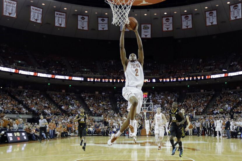 Texas' Demarcus Holland (2) scores on a fast break against West Virginia during the first...