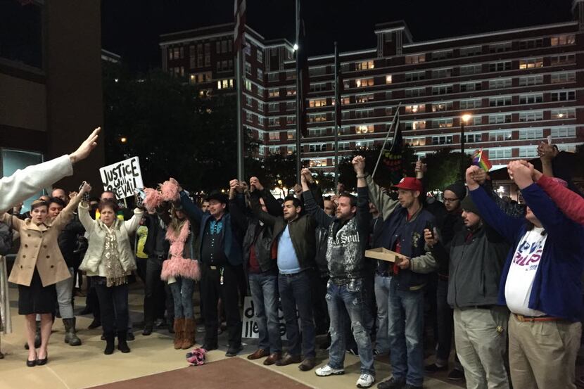  A crowd sings âWe Shall Overcomeâ outside the Dallas Jack Evans Police Headquarters in...