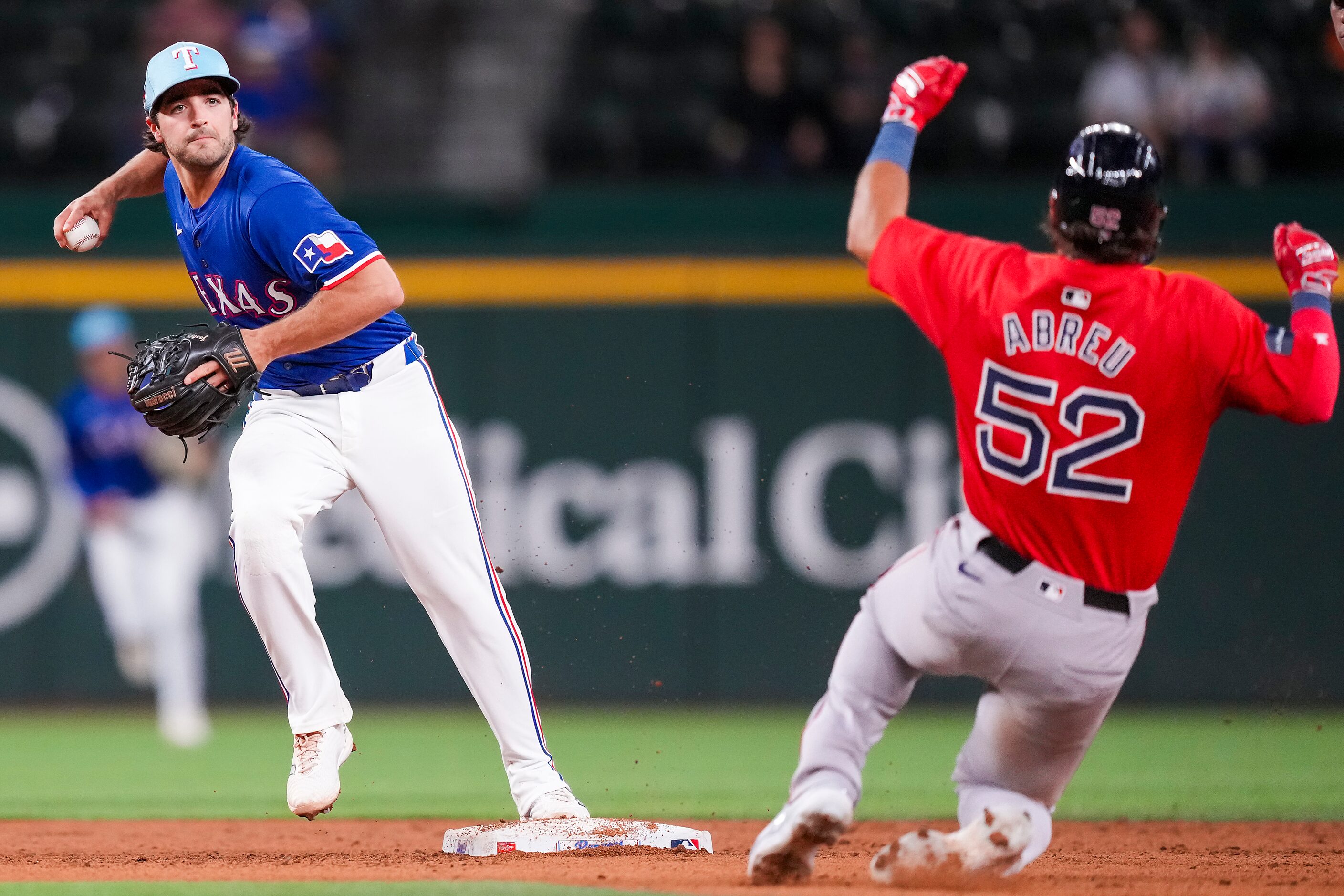 Texas Rangers infielder Josh Smith tried to turn a double play over Wilyer Abreu of the...