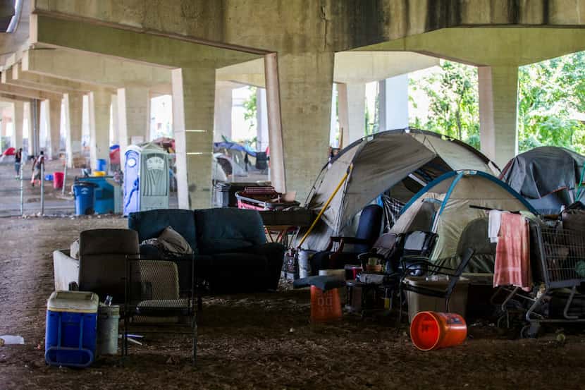 Tents are set up in a homeless encampment under Interstate 30 at Haskell Avenue on Thursday,...
