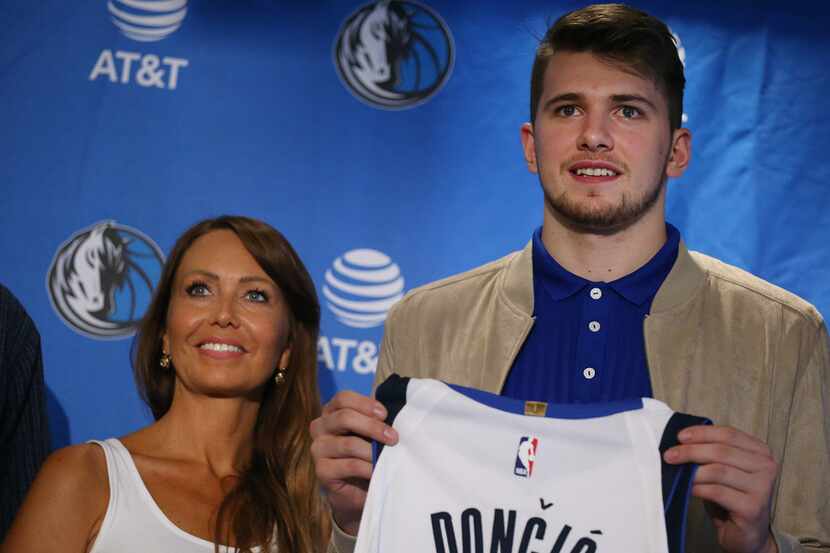 Luka Doncic, here at his introductory news conference with his mother, Mirjam Poterbin, will...