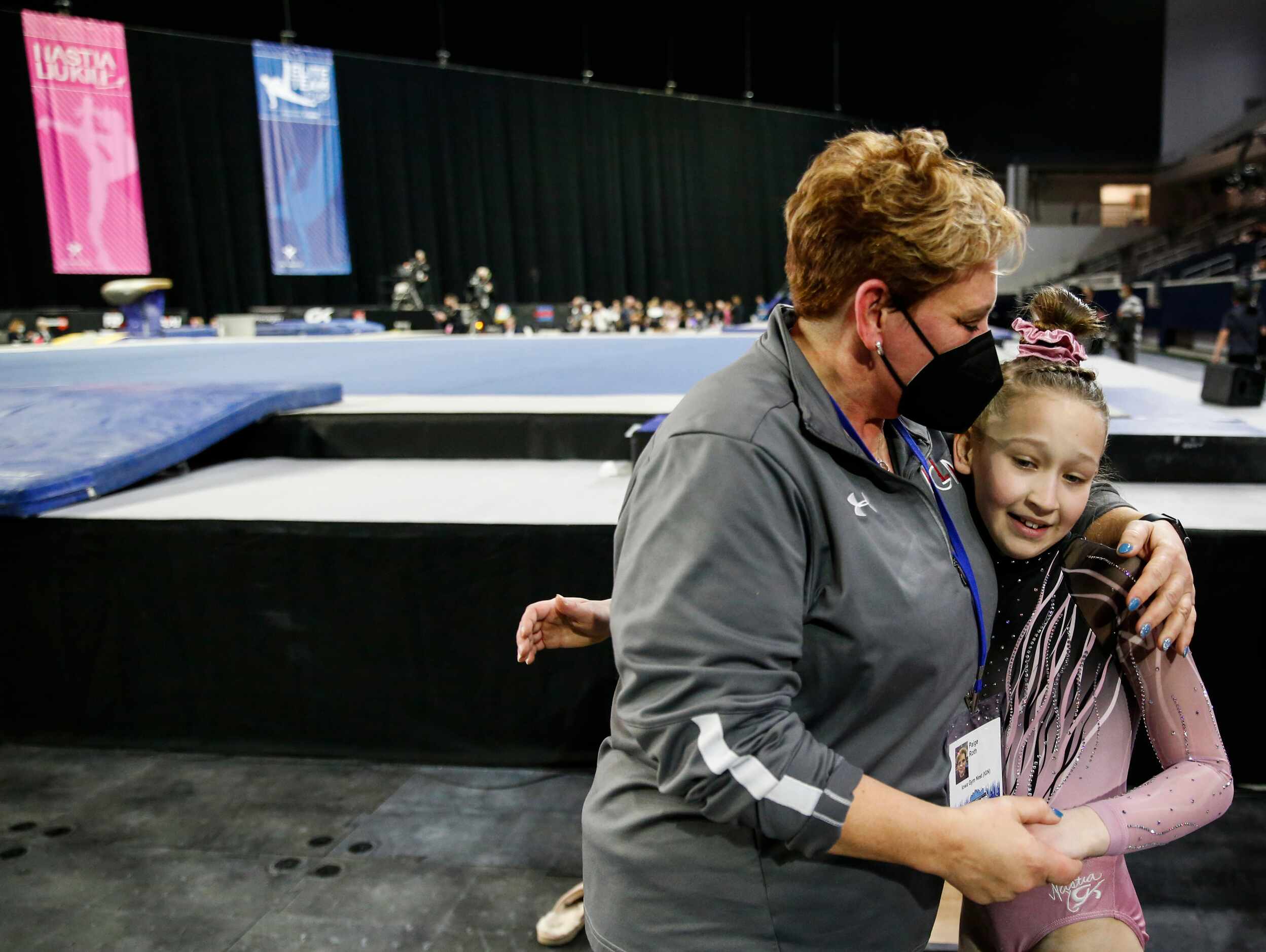 Greta Krob, right, of Iowa Gym Nest, Tipton, Iowa hugs her coach Paige Roth after scoring...