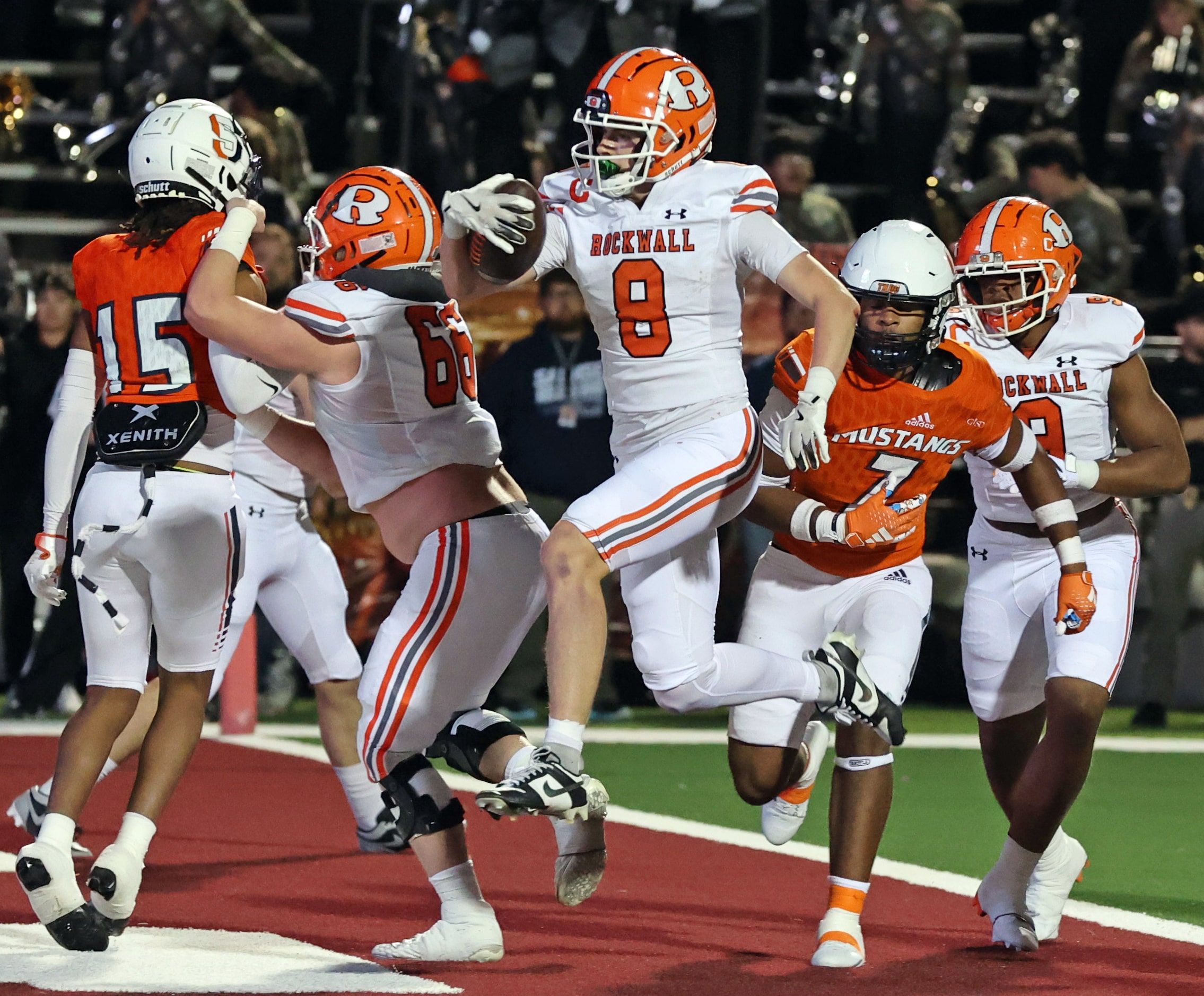 Rockwall High WR Triston Gooch (8) dashes into the end zone to add a two point conversion to...