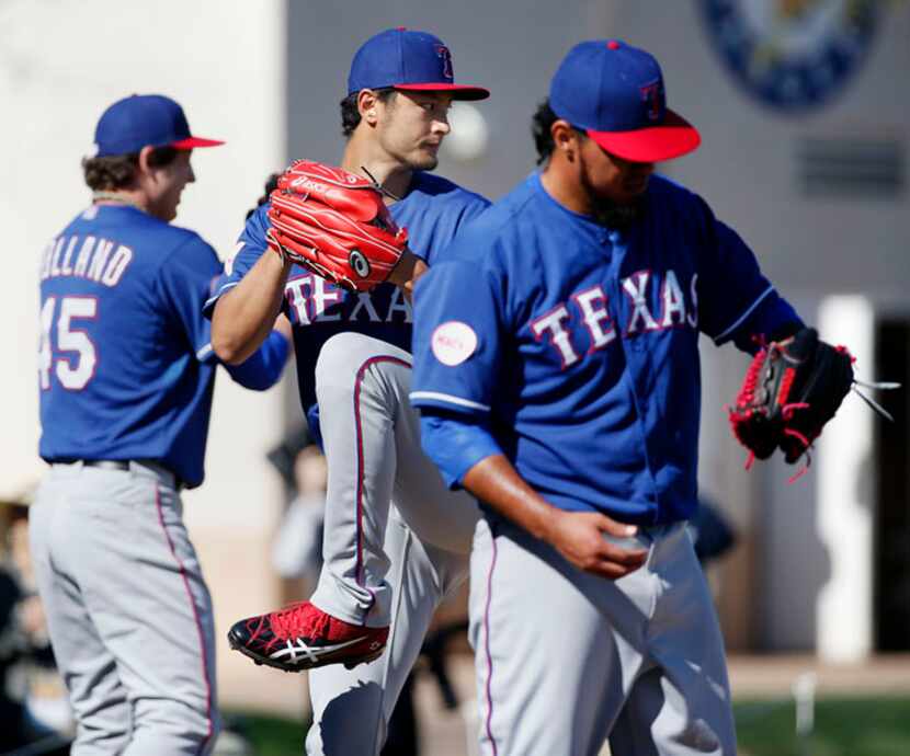  Texas Rangers pitcher Yu Darvish throws in a bullpen session before participating in live...