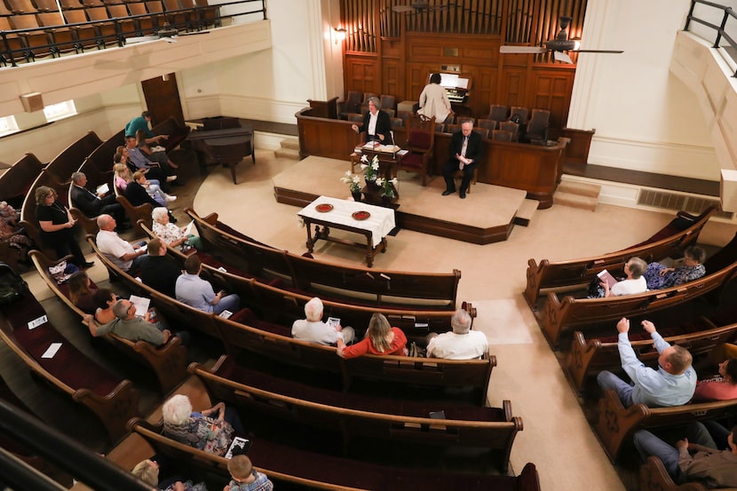 Julie Adkins (center), pastor for Milford Presbyterian Church, began the last service for...