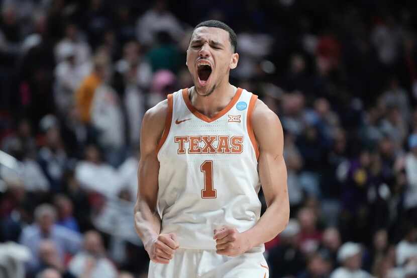 Texas' Dylan Disu celebrates during the final seconds of the second half of a second-round...