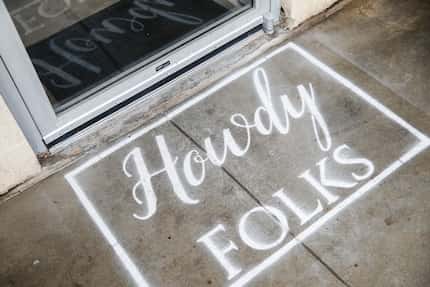 A "howdy, folks" welcome mat is painted on the ground at Corndog With No Name. The friendly...