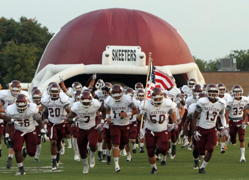 The Mesquite Skeeters run from the team's inflatable helmet prior a game against Arlington...