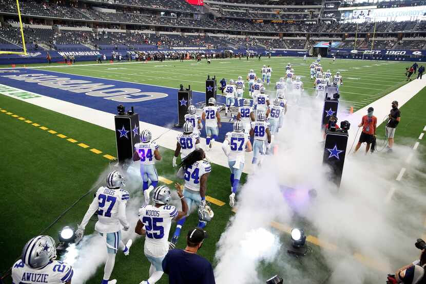 Dallas Cowboys players take the field before playing the Atlanta Falcons in the home opener...