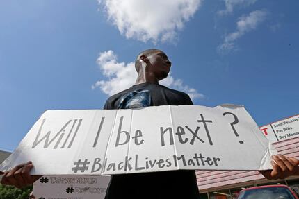  Niamke Ledbetter, of Oak Cliff, Texas, holds a sign at a Black Lives Matter protest on Park...