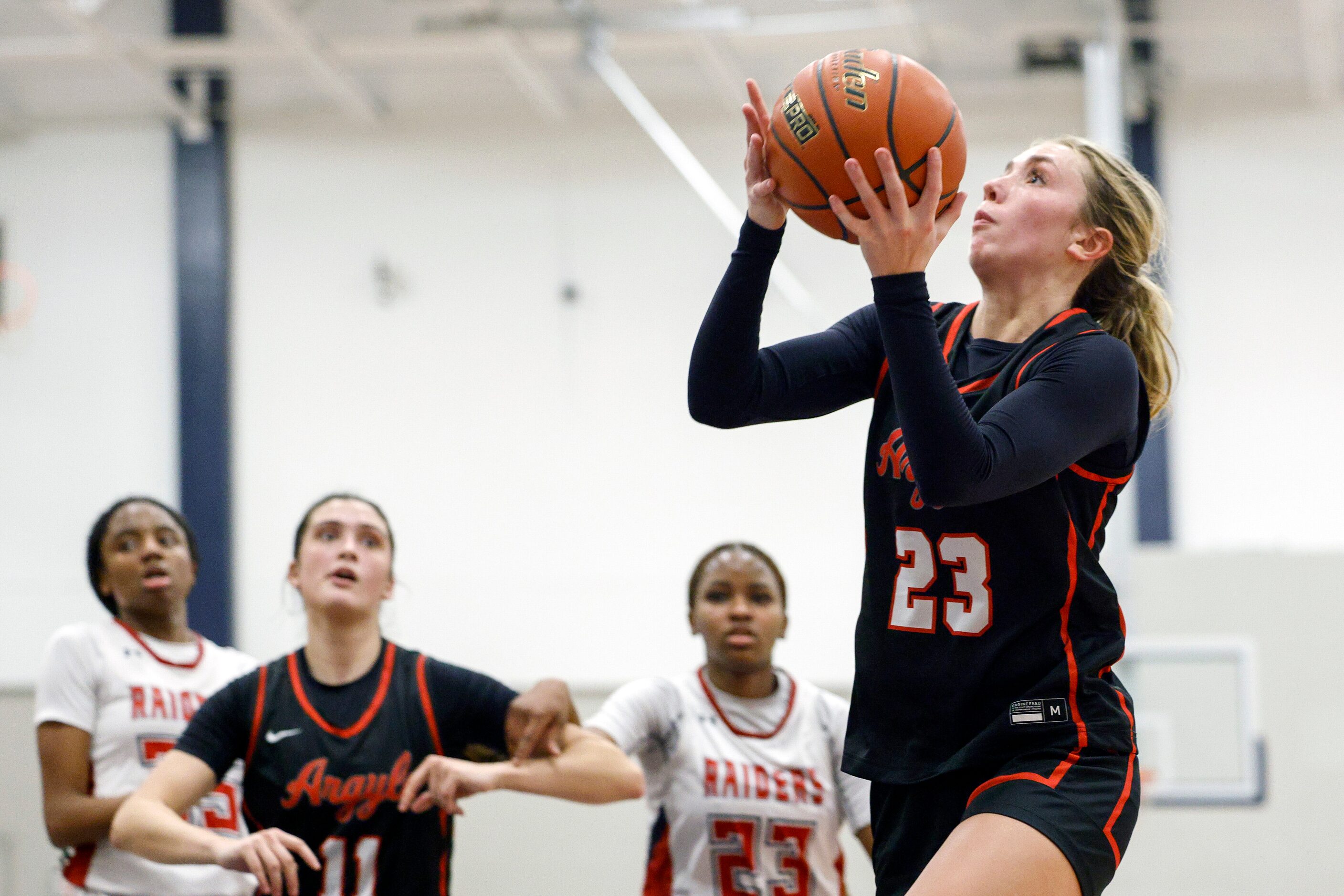 Argyle guard Kennedy Hafer (23) attempts a layup during the second half of a District 7-5A...