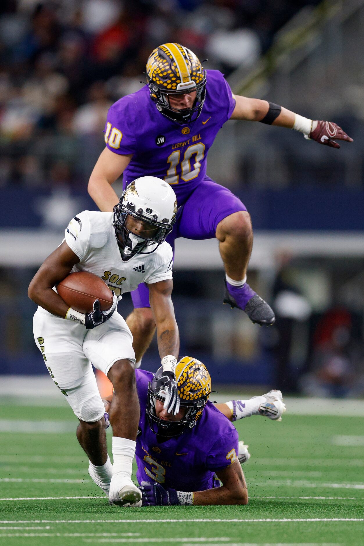 South Oak Cliff running back Ke'Undra Hollywood (12) avoids a tackle from Liberty Hill...