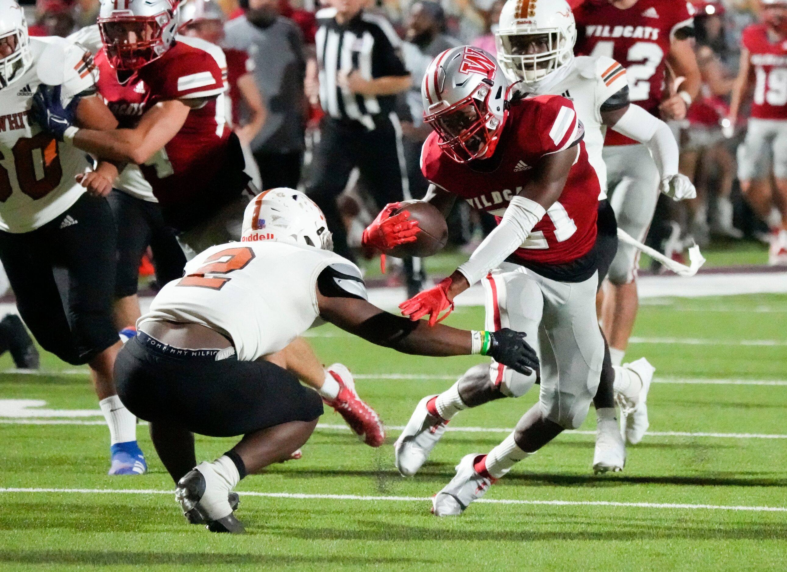 Woodrow Wilson junior Boris Taylor (21) avoids a tackle by W.T. White Daviawn Bishop (2) on...