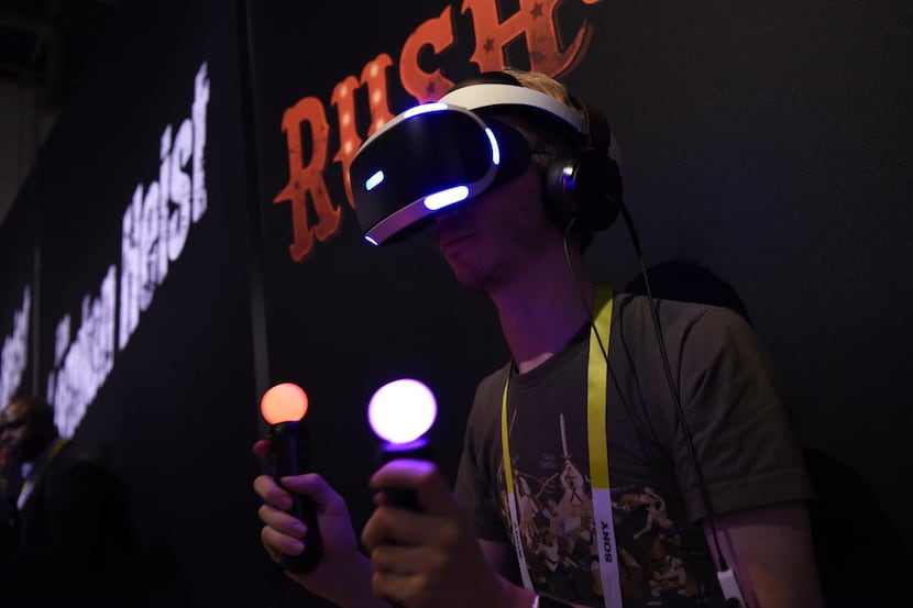  An attendee demonstrates the Sony Corp. PlayStation virtual reality (VR) gaming headset...